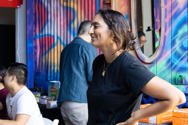 A woman poses is seen with her hands on hips at an event